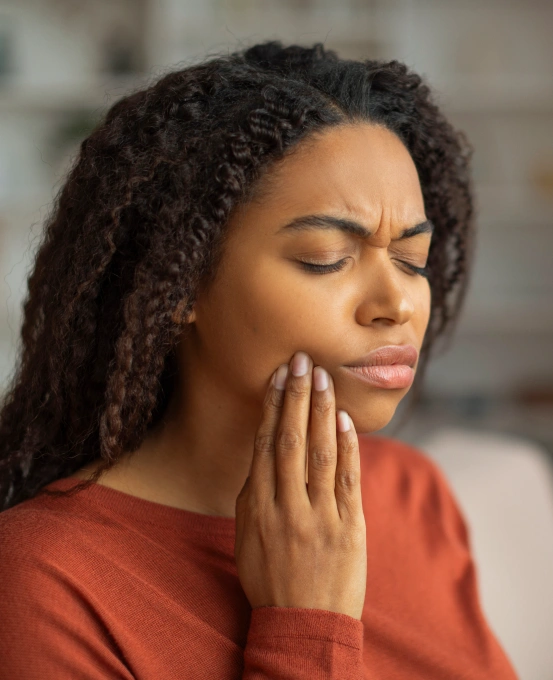 Woman holding her jaw because of severe tooth pain