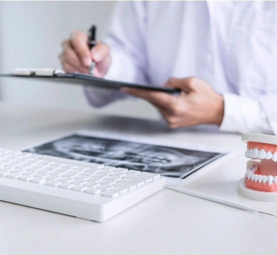 Dentist reviewing patient information on a clipboard