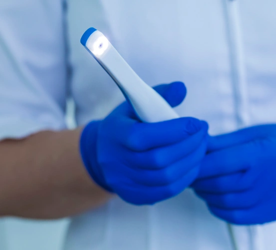 Dentist holding an intraoral camera for dental imaging